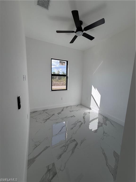 Modern interior space featuring sleek tile flooring with a marbled pattern, crisp white walls, and a contemporary black ceiling fan with integrated lighting