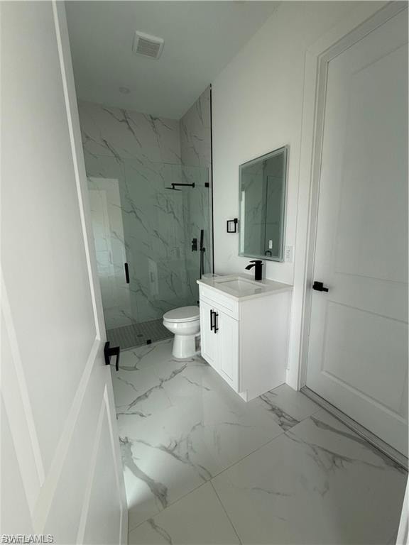 Contemporary bathroom featuring large format marble-look floor tile, a glass-enclosed shower with matching marble-look wall tile, a white vanity with integrated sink, and matte black fixtures