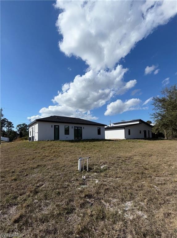Expansive grassy lot featuring two detached structures