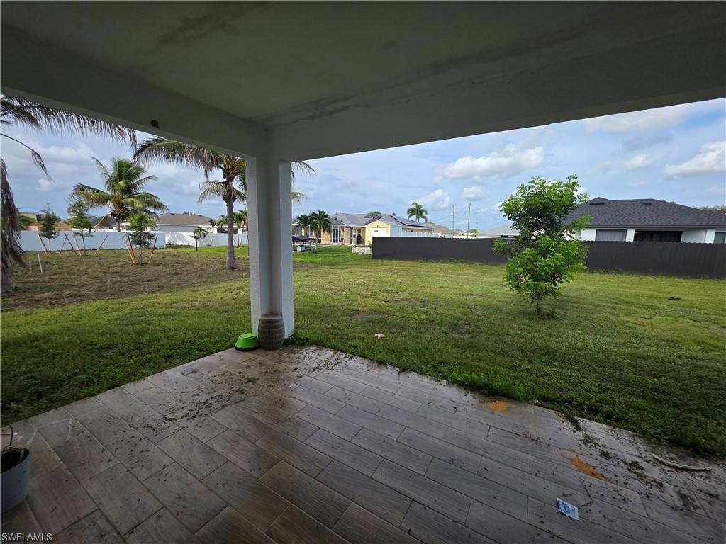 Covered patio featuring wood-finish tile flooring