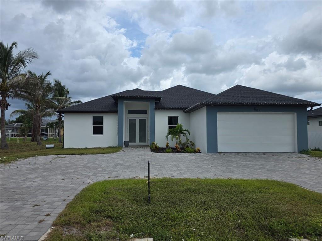 Modern architectural home featuring a striking two-tone exterior with crisp white and charcoal finishes, complemented by a geometric roofline with multiple pitched peaks