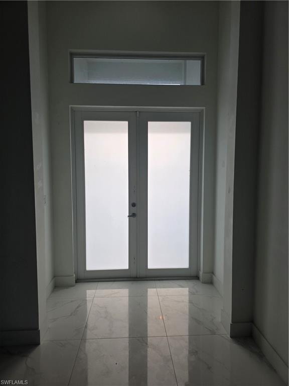 Double-door entry with frosted glass panels and a transom window above