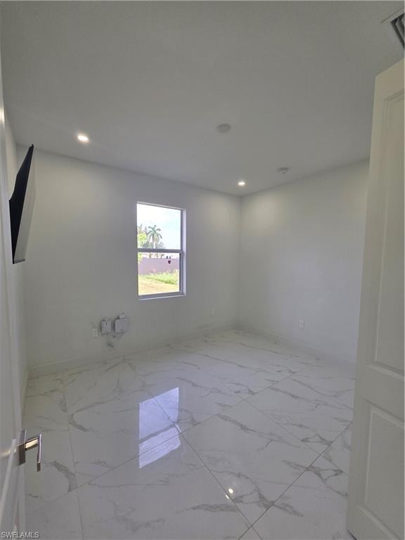 Room featuring large format tile flooring, recessed ceiling lighting, and a single window