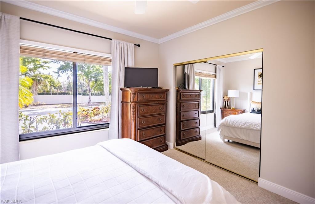 Bedroom with neutral wall tones and crown molding