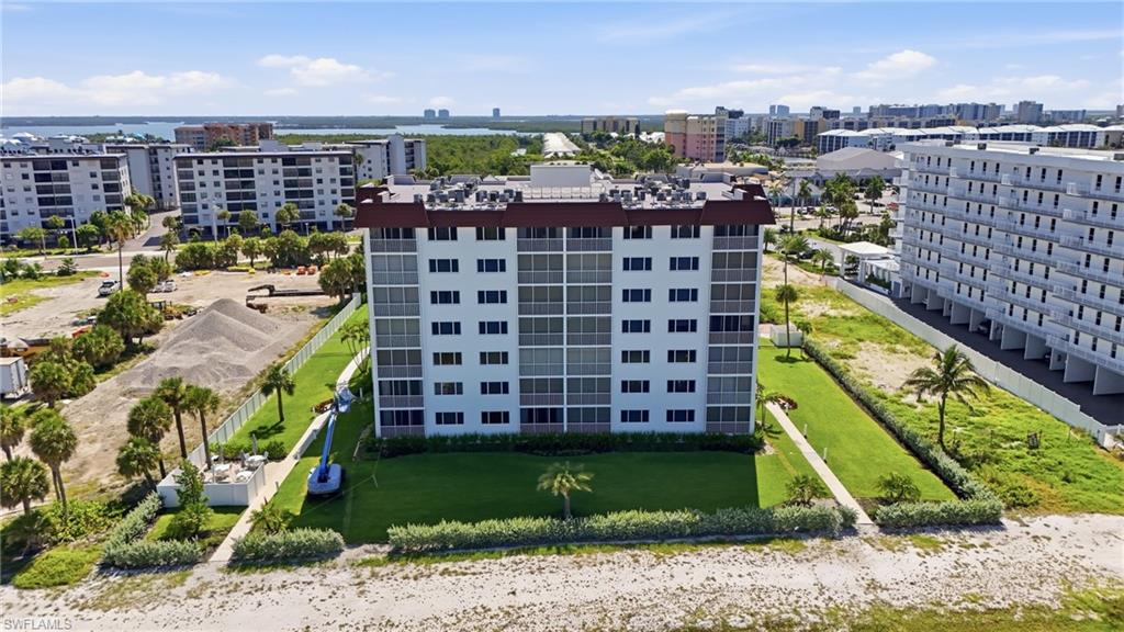 Modern multi-story residential building featuring a symmetrical façade with regularly spaced windows, horizontal banding details, and clean architectural lines - Virtually Edited Image