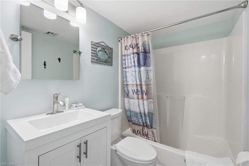Integrated vanity with a single basin sink, brushed nickel faucet, and under-cabinet storage