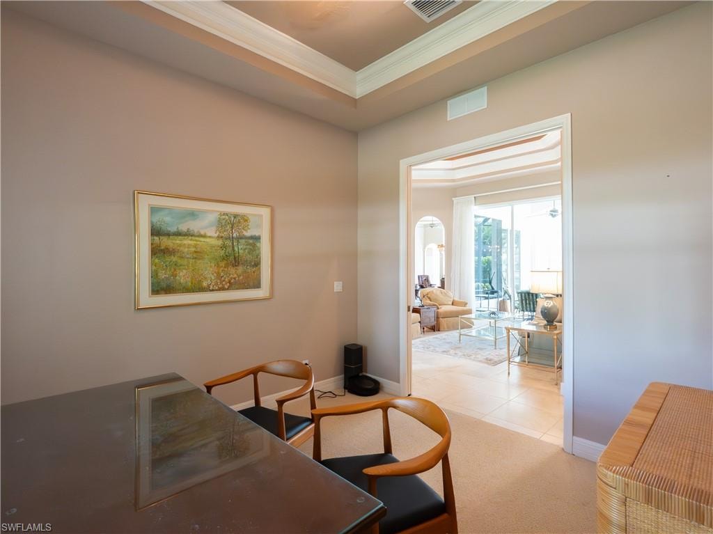 Tray ceiling, recessed lighting, arched entryway, tile flooring, glass sliding doors