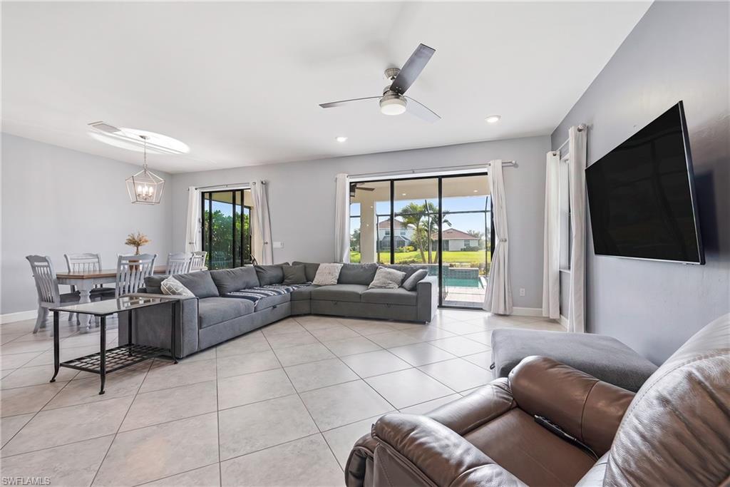 Open-concept living area with tile flooring and recessed lighting