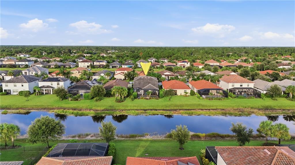 Aerial perspective showcasing a residential community with a prominent waterway
