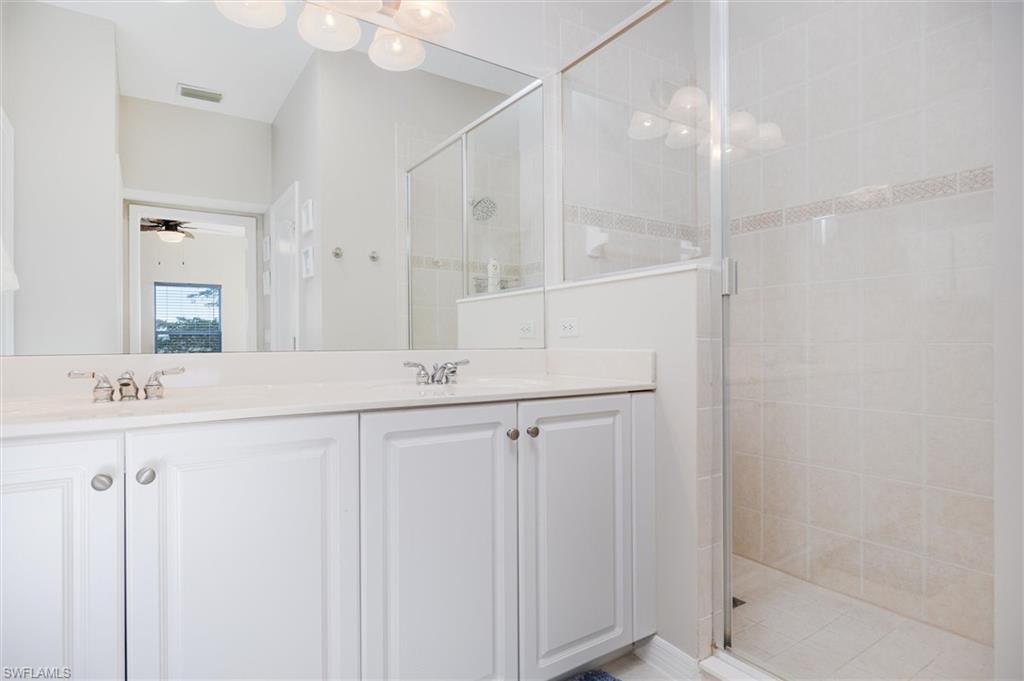 Dual vanity with white cabinetry and integrated sinks