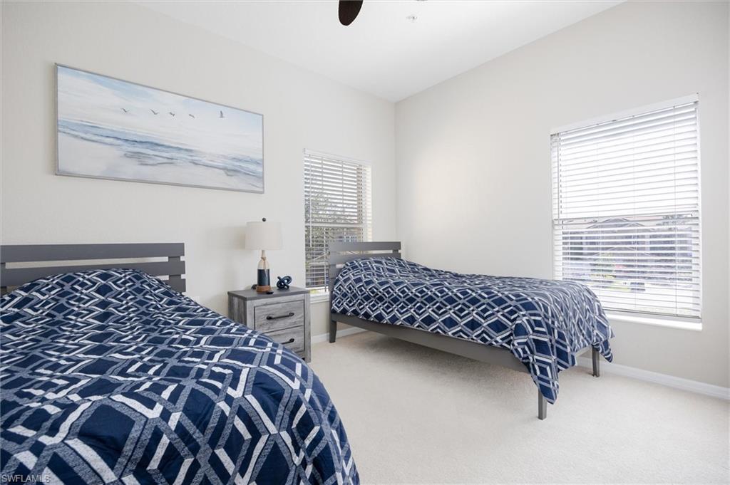 Bright room featuring light-toned walls and carpet flooring