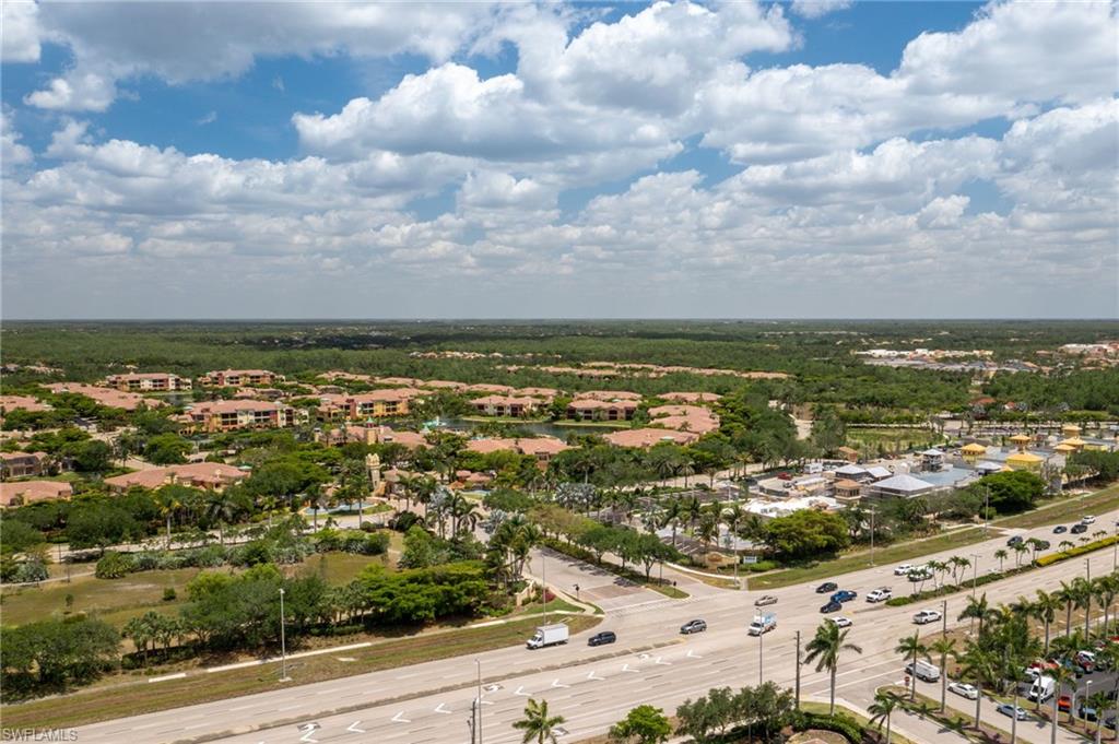 Expansive aerial landscape showcasing a diverse residential area with multiple-story buildings and single-story structures