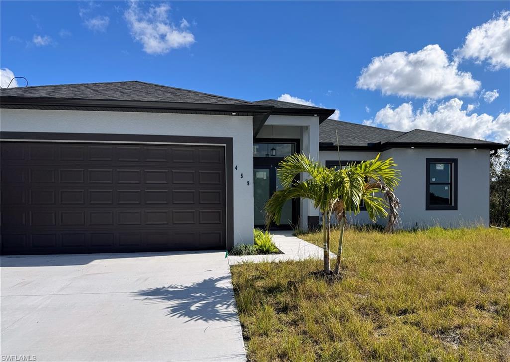 Contemporary single-story residence featuring a dark asphalt shingle roof, light stucco exterior, and black window trim
