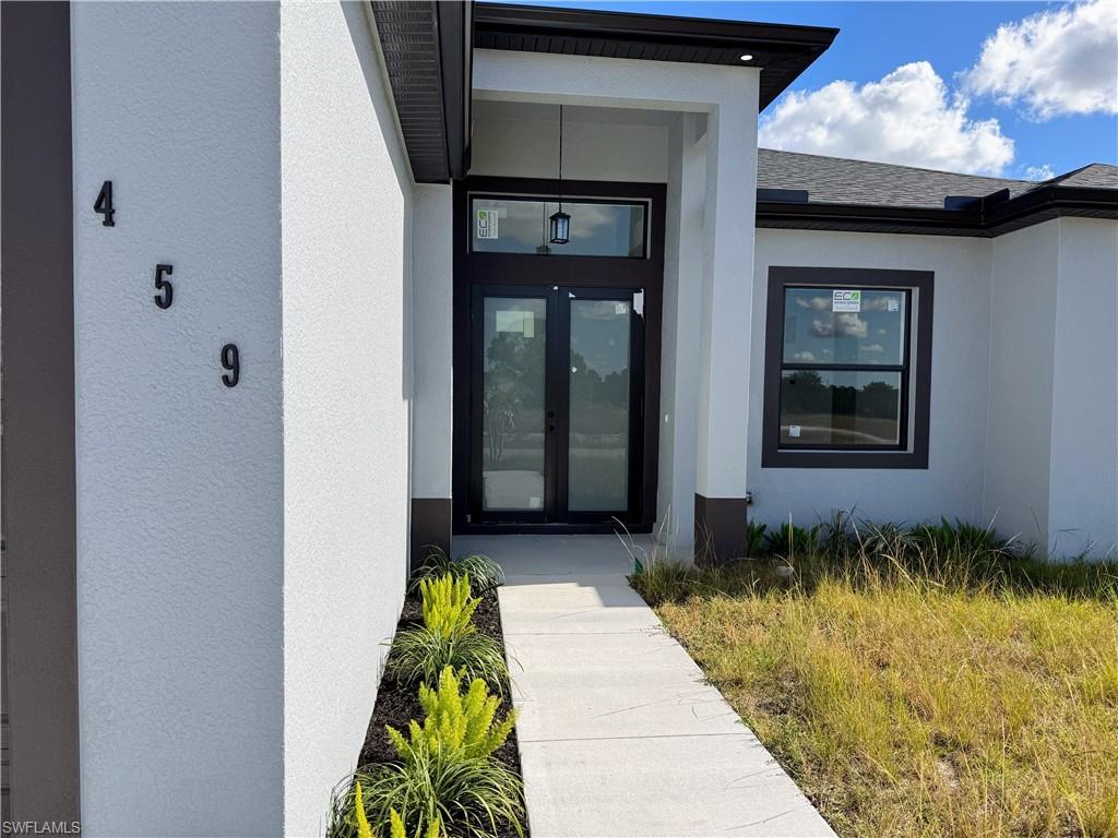 Contemporary stucco exterior with a dark trim accent