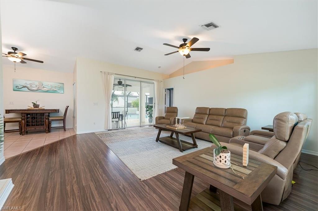 Bright Spacious Living Room with Fireplace & Sliders that open to Pool  Lanai area.