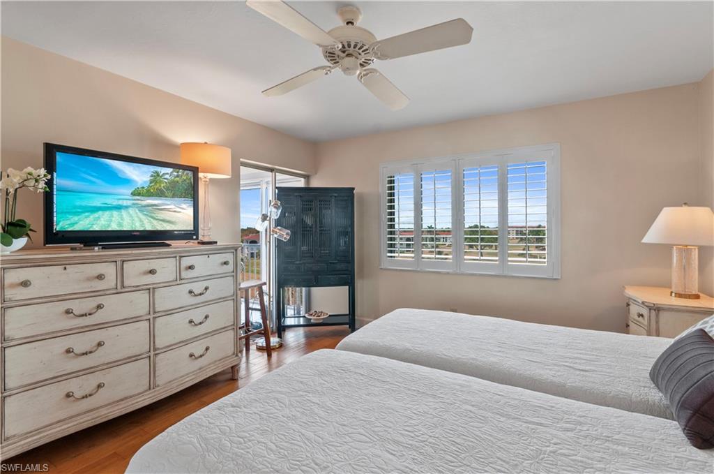 Master bedroom, wood floors, sliding door to lanai, plantation shutters, ensuite. Hurricane windows.