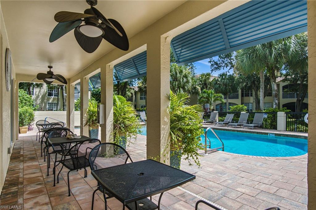Covered patio with paver flooring and multiple ceiling fans