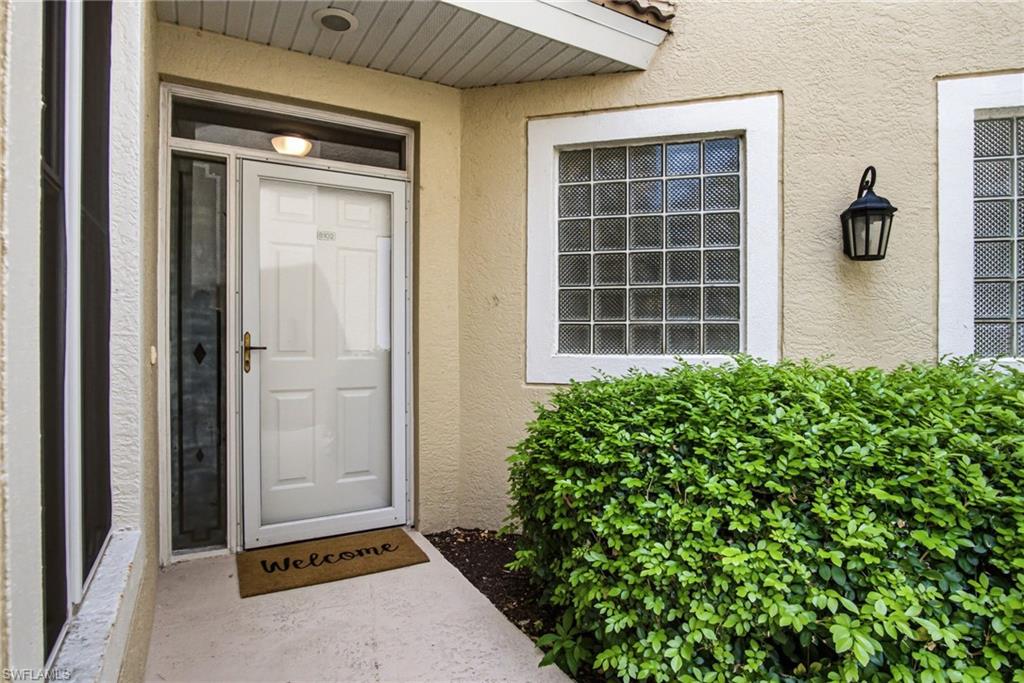 Welcoming entry featuring a white panel front door with sidelights, recessed overhead lighting, and a "Welcome" doormat