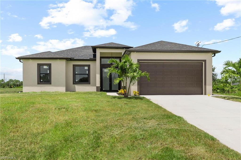 Contemporary single-story residence featuring a neutral stucco exterior, dark shingle roofing, and a two-car garage with a panel-style door