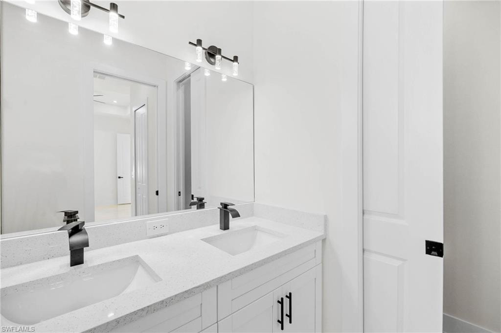 Double vanity with integrated sinks, quartz countertop, and matte black hardware
