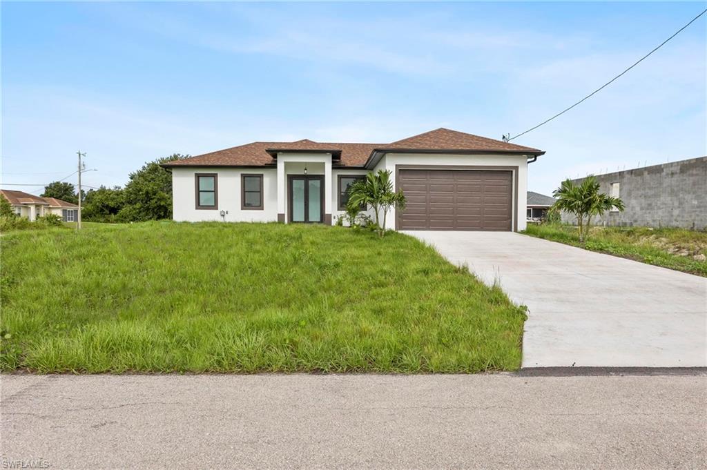 Contemporary-style residence featuring a prominent brown garage door and a concrete driveway