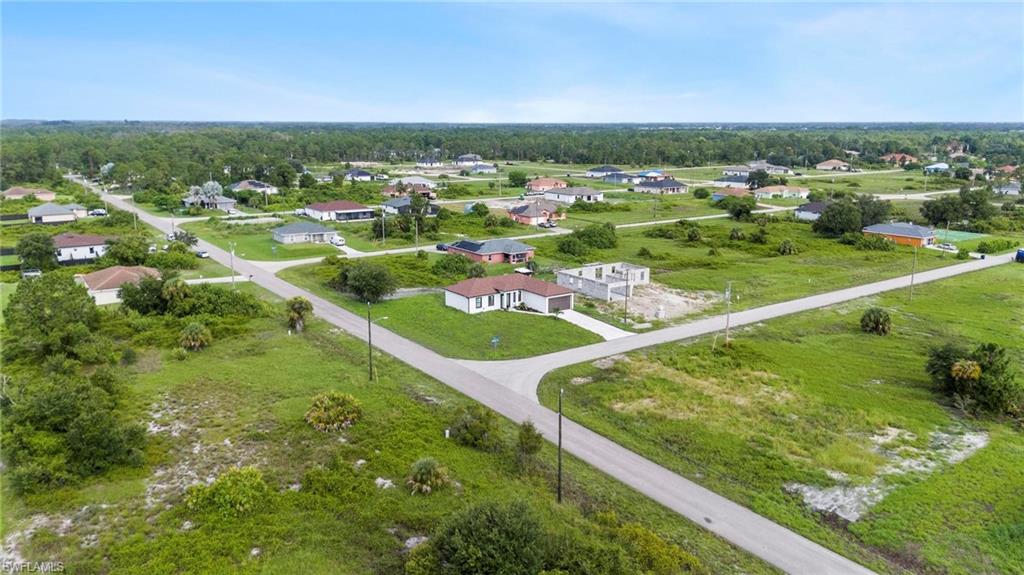 Aerial perspective showcasing a residential area with established homes and developing lots