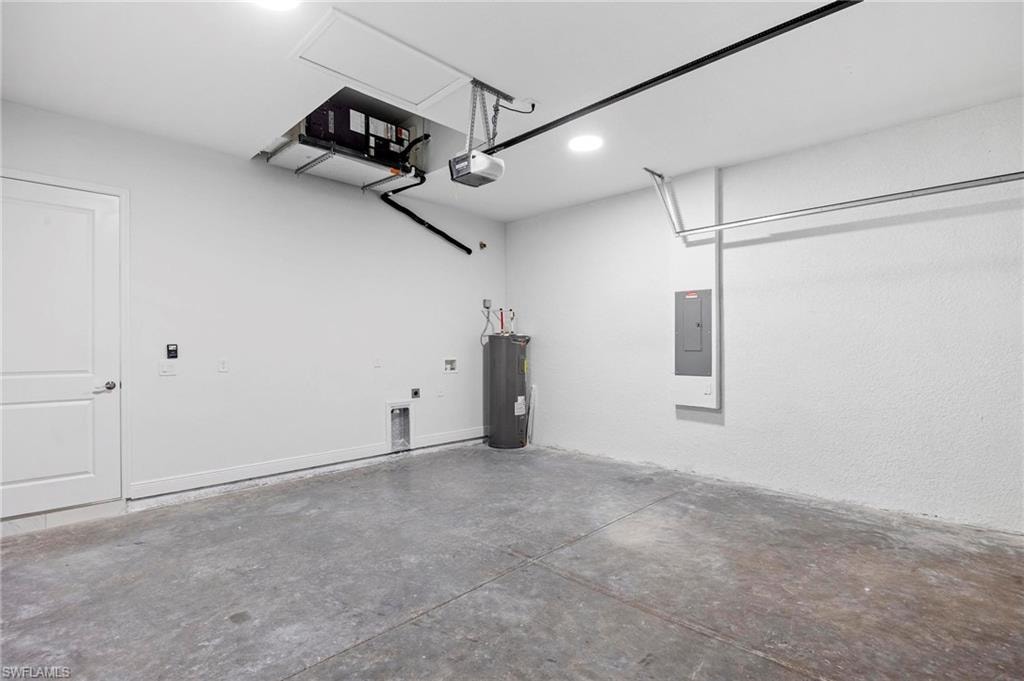 Spacious garage with a concrete floor, white walls, and an overhead garage door opener
