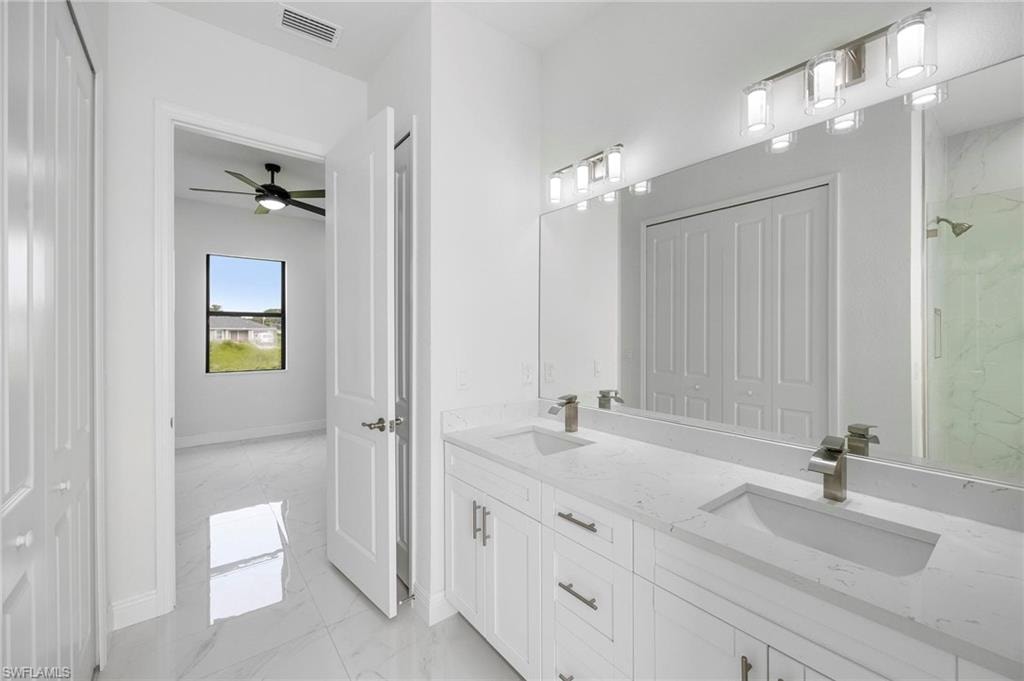 Dual vanity with undermount sinks, stone countertops, and brushed nickel fixtures