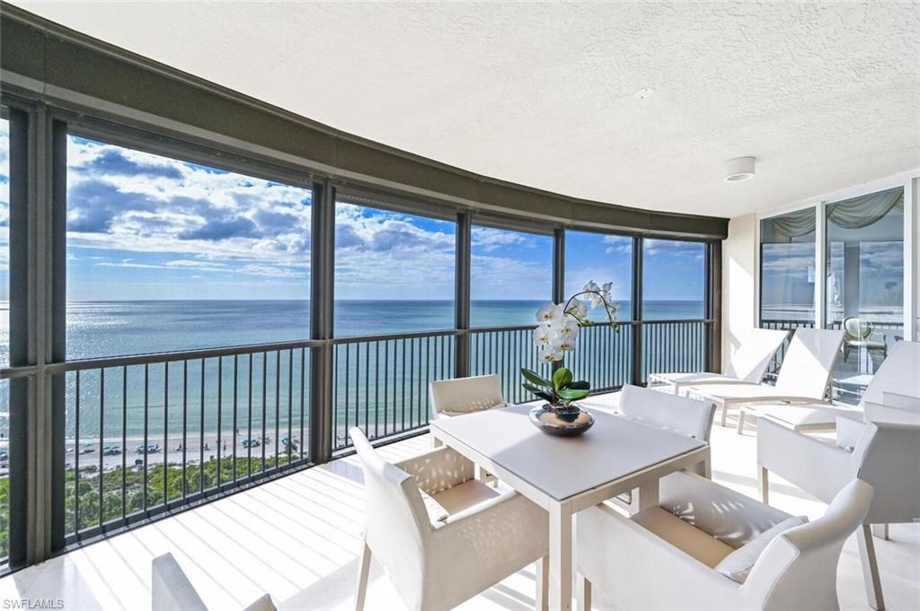Expansive balcony featuring a curved design and a perimeter of floor-to-ceiling windows