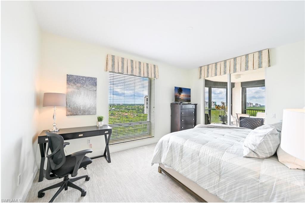 Bright interior featuring a floor-to-ceiling window with horizontal blinds, providing abundant natural light