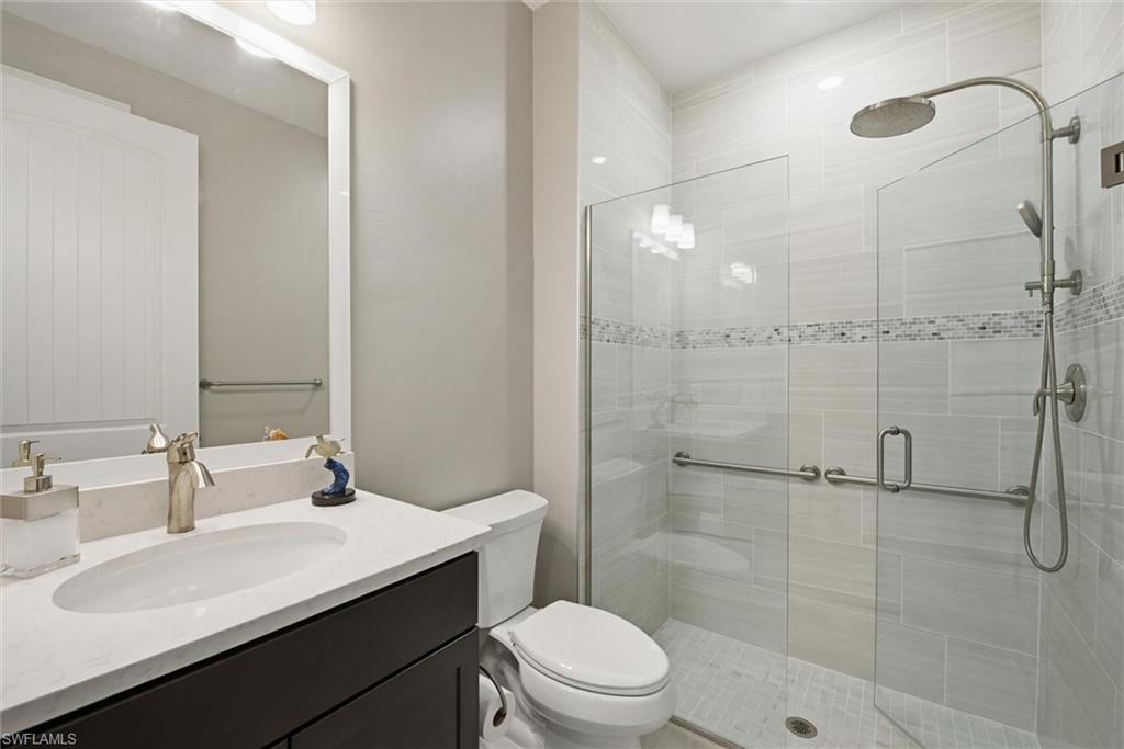 Bathroom featuring vanity and a shower stall