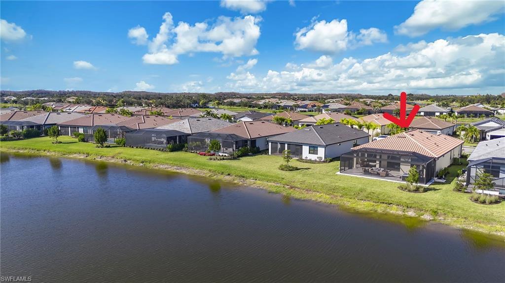 Aerial perspective of suburban area with a nearby body of water