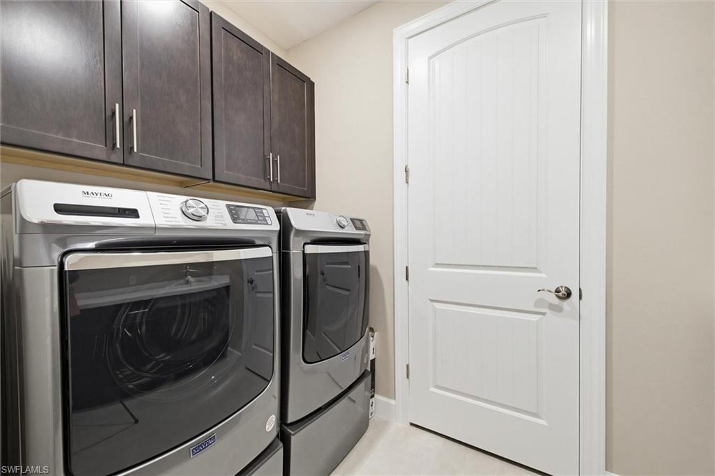 Laundry area featuring cabinet space and washer and clothes dryer