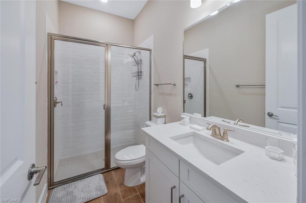 Contemporary bathroom featuring a spacious walk-in shower with subway tile surround and brushed nickel framing