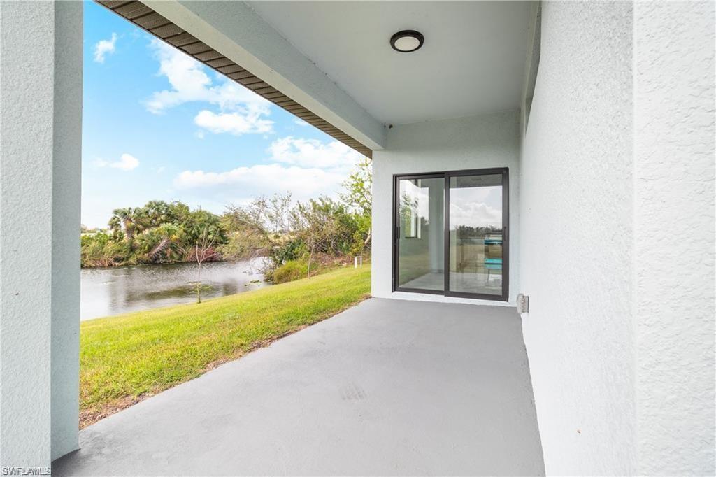 Covered concrete patio overlooking a natural waterway