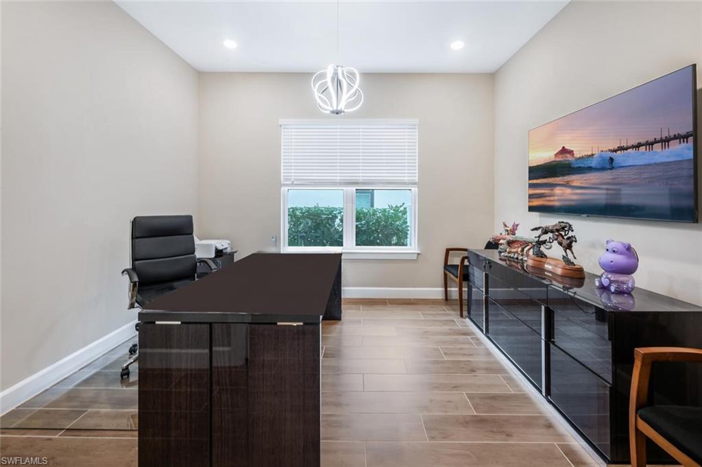 Room featuring wood-finish tile flooring, recessed lighting, and a modern ceiling fixture
