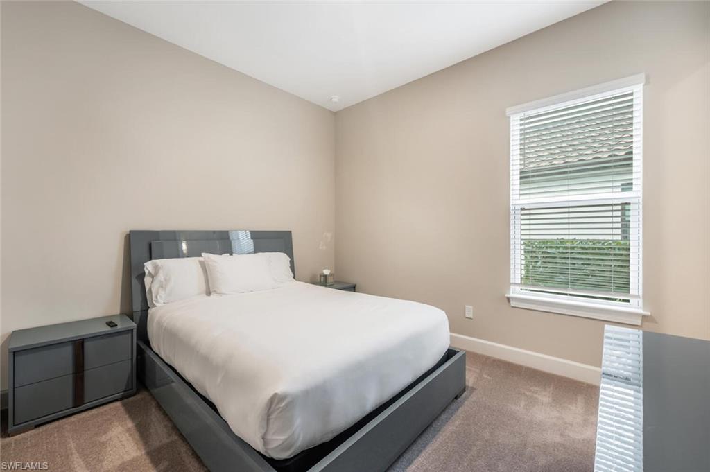 Neutral wall tones with a single window featuring horizontal blinds