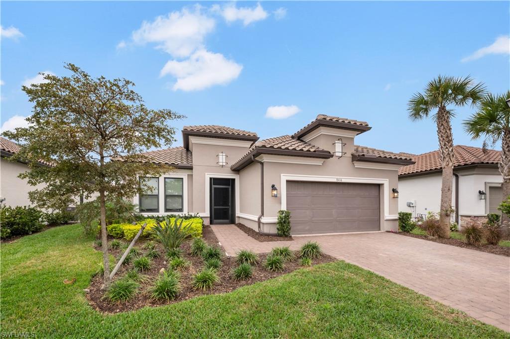 Mediterranean-style residence featuring a tile roof, stucco exterior, paver driveway, integrated garage, and a screened entry