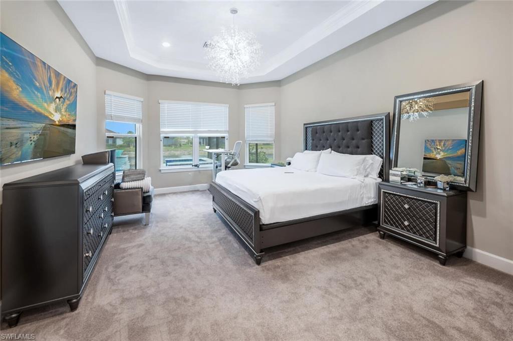 Tray ceiling with recessed lighting and contemporary chandelier