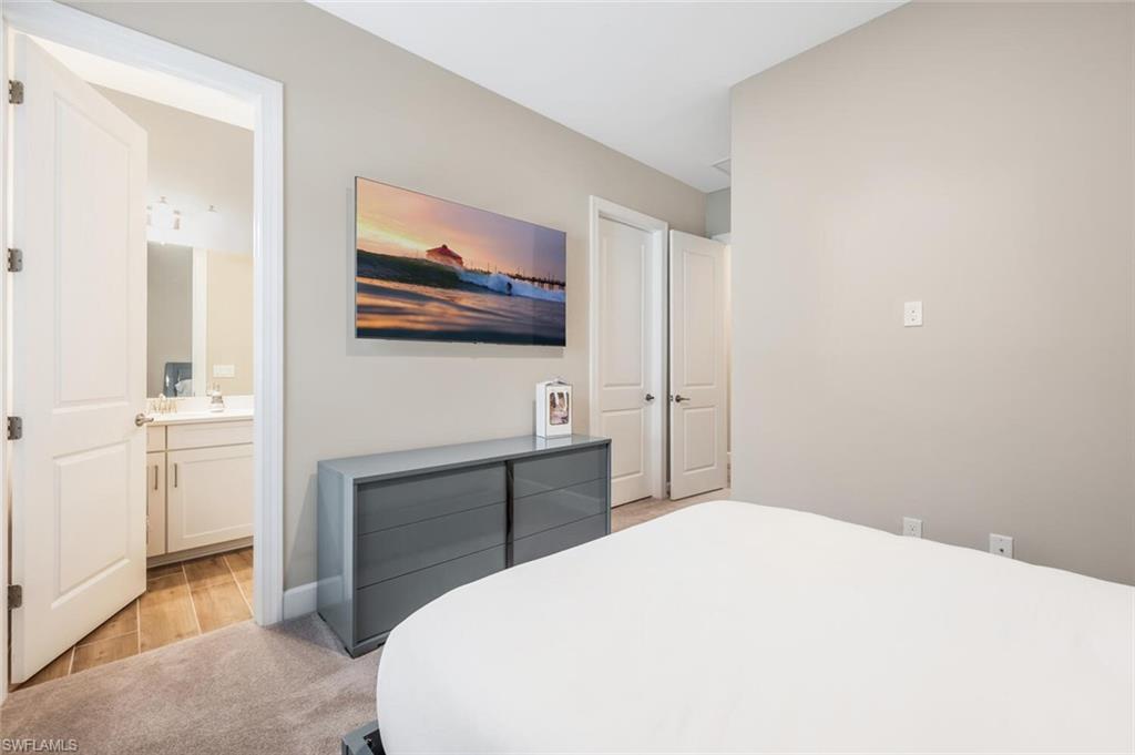 Bedroom with carpeted flooring and neutral wall tones