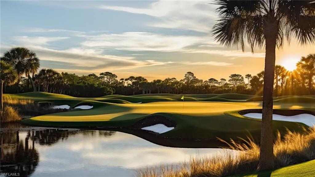 Manicured golf course featuring a water hazard, sand traps, and a putting green with a flagstick