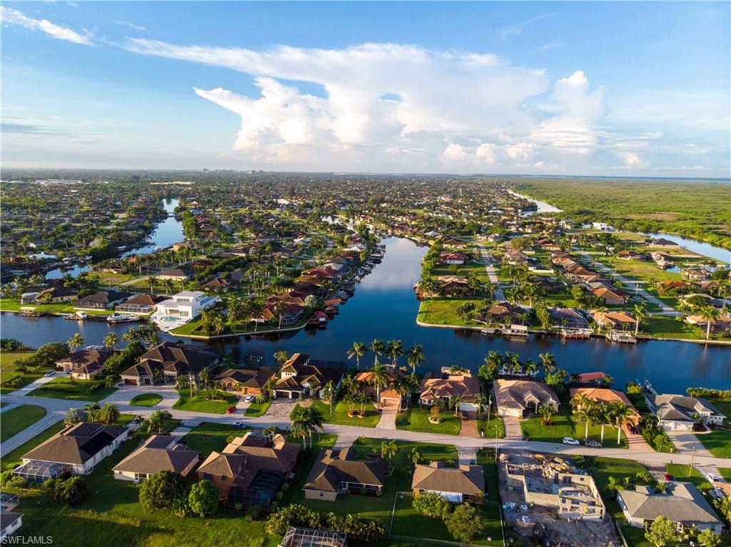 Aerial perspective showcasing multiple properties with canal frontage