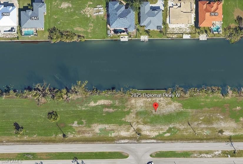 Expansive waterfront lot featuring direct canal frontage and direct road access