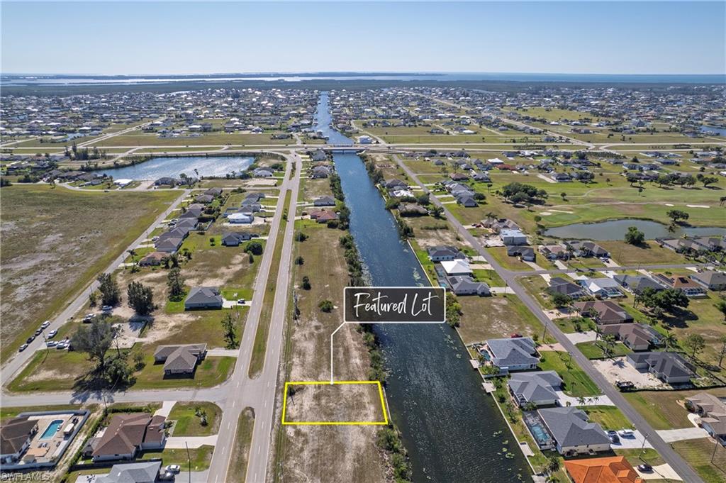 Featured lot with canal frontage, road access, and cleared land