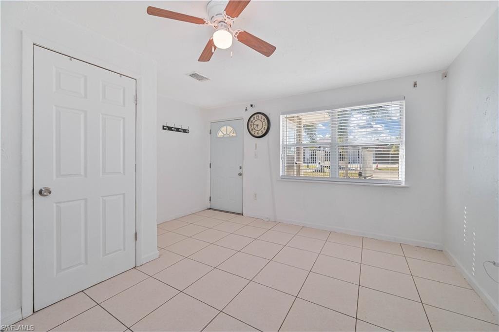 Spare room featuring light tile patterned flooring and a ceiling fan
