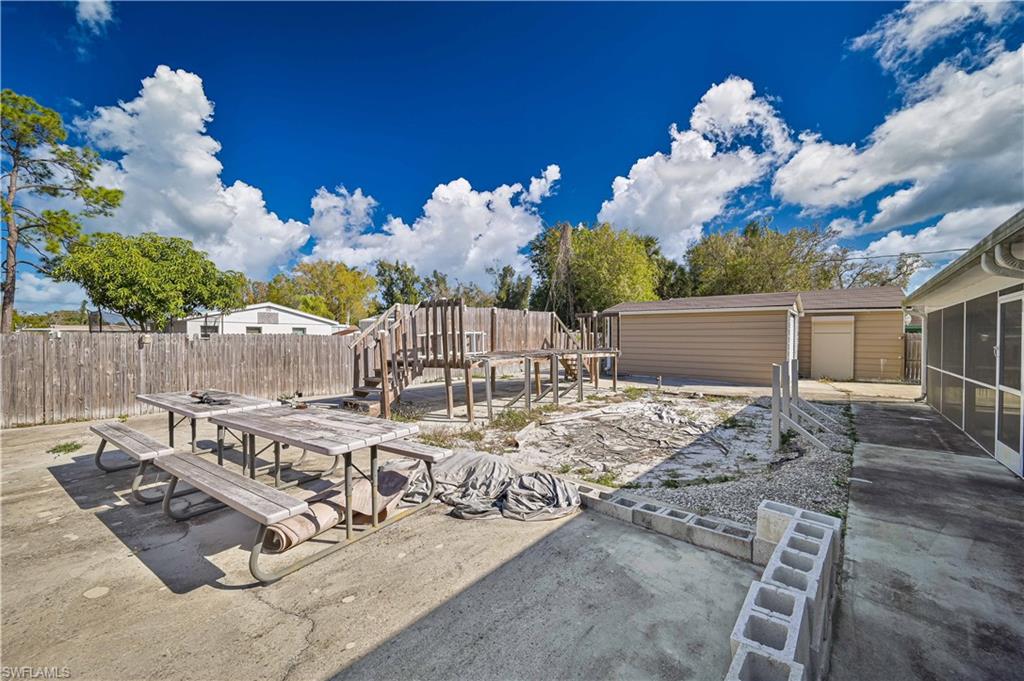 Fenced backyard featuring outdoor dining area and a patio