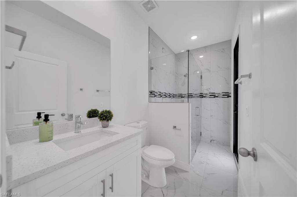 Contemporary bathroom featuring a white vanity with an integrated rectangular sink and a light-toned countertop