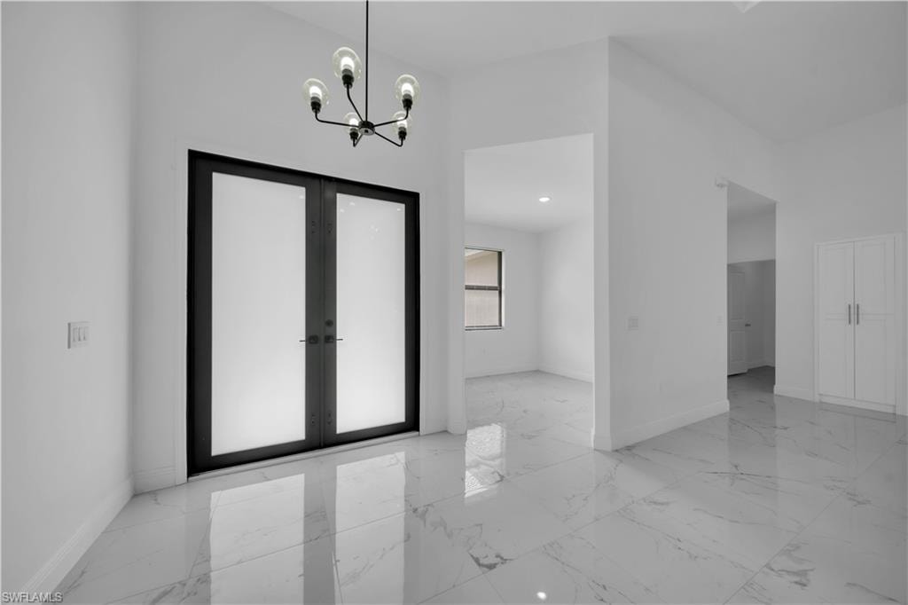 Double-door entry featuring frosted glass panels and matte black framing