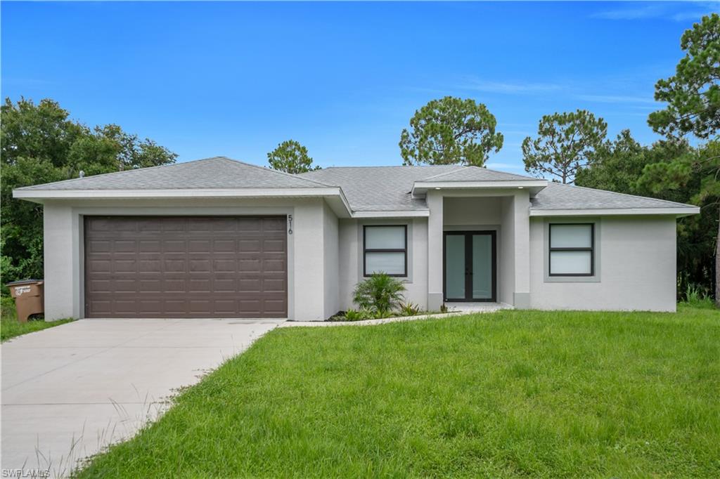 Contemporary single-story residence featuring a light gray stucco exterior, a dark brown garage door, and a gray shingle roof