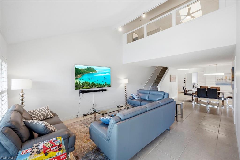 Living Room Area with View of Dining Area and Loft Above